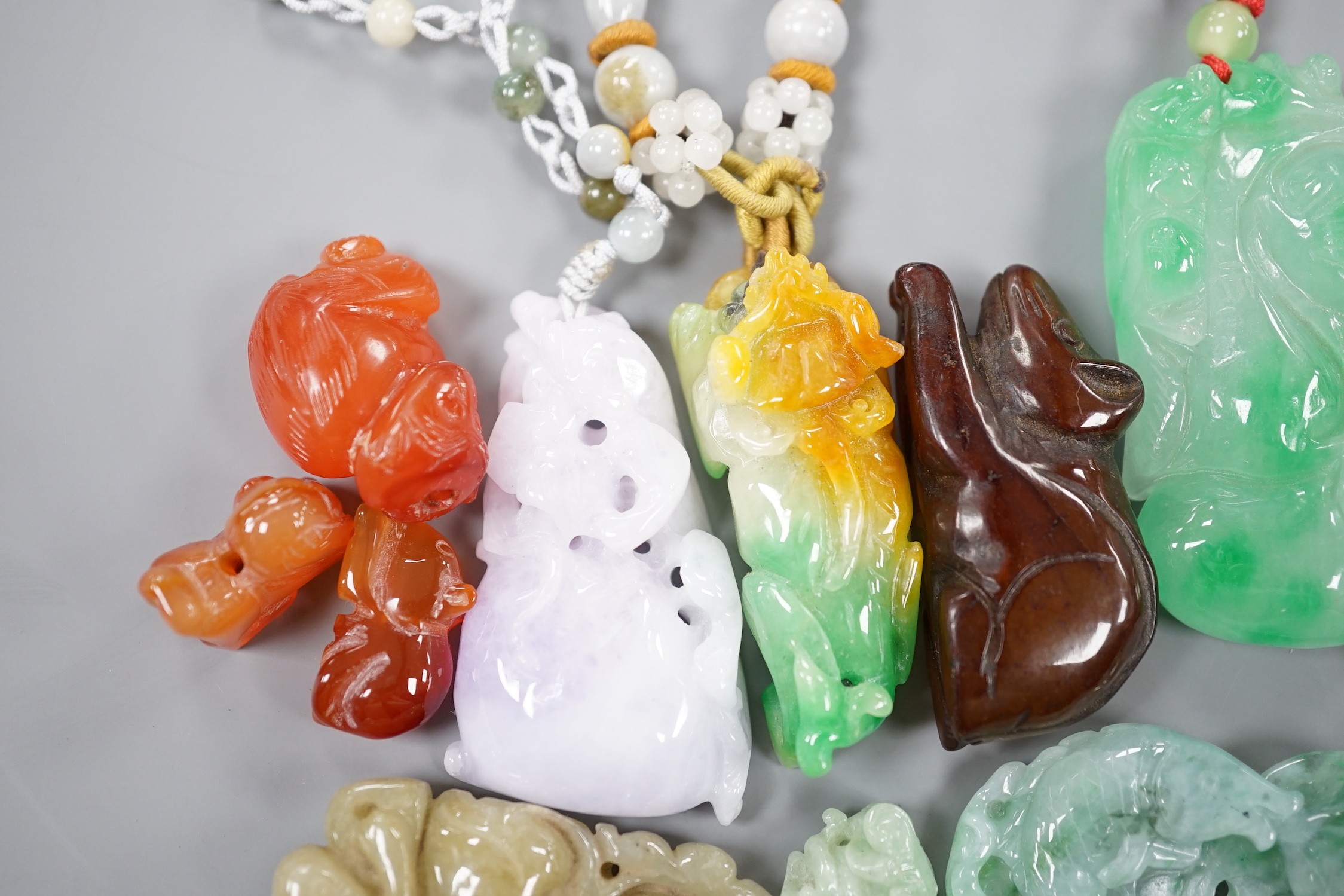A group of ten jadeite and hardstone carvings and pendants